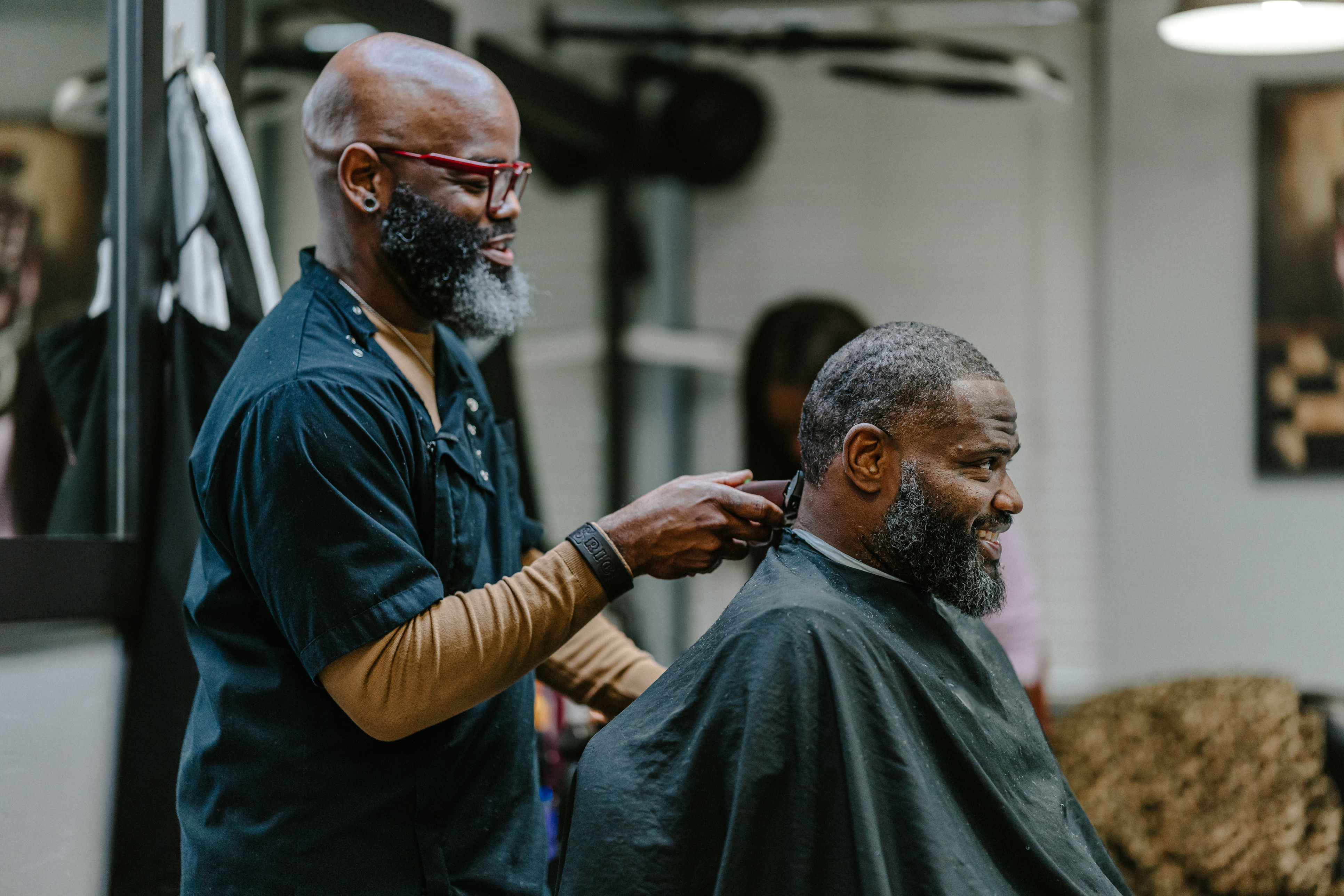 A man being trimmed by a barber