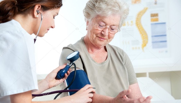 Elderly woman having her blood pressure taken