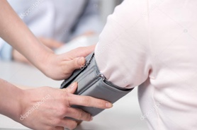 Close up of a persons arm having their blood pressure measured